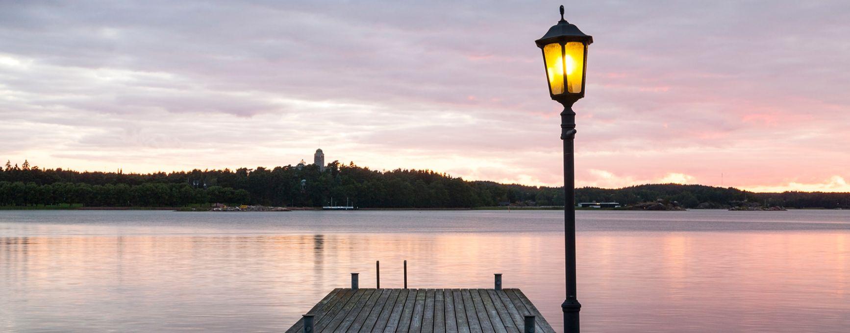 A jetty with a single lamp post beside the sea in Naantali.